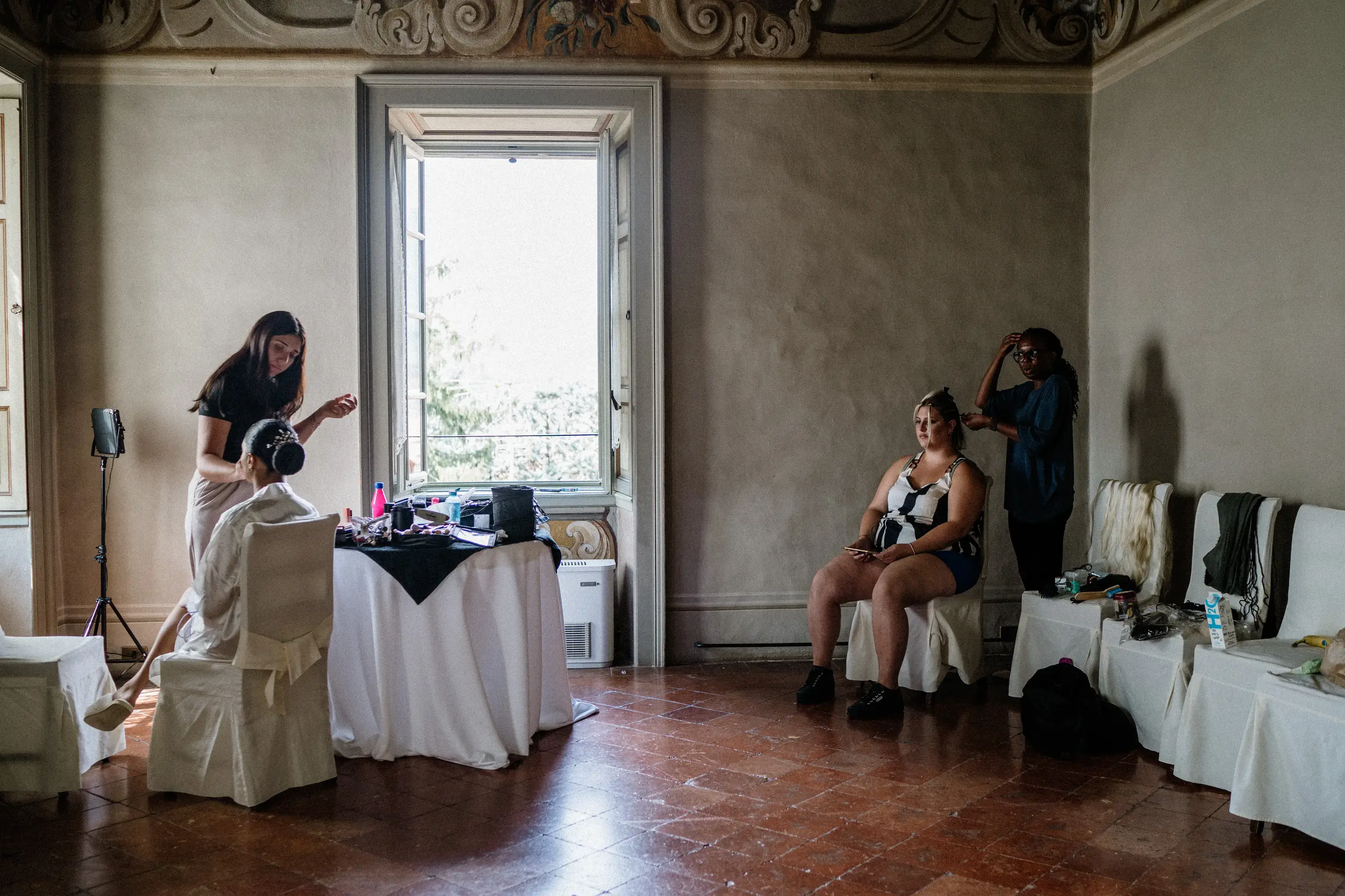 A hair and makeup department set up in a wedding venue